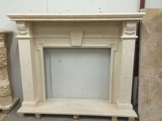 a white marble fireplace surround in a room