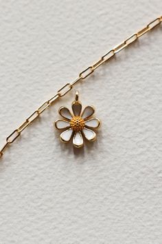 14k Gold filled enamel white daisy flower charm is sweet and happy. Add some joy to your charm necklace with this cute bloom. Hand make your custom charm necklace in Laguna Beach or build your piece online through adding a base necklace and your selection of charms. Leave us a note on your order for any special requests. 14K gold filled Tarnish resistant Enamel Dainty Flower Charm For Gift, Dainty 14k Gold Charm Necklace With Flower Charm, Everyday Flower Charm Pendant Necklace, 14k Gold Flower Charm Necklace With Pendant, White Sterling Silver Charm Necklaces For Mother's Day, Cute White Everyday Necklace, Cute Everyday White Necklace, White Sterling Silver Jewelry With Flower Charm, Handmade White Charm Necklaces For Mother's Day