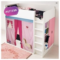 a white bunk bed with pink and blue curtains on the top, and shelves below