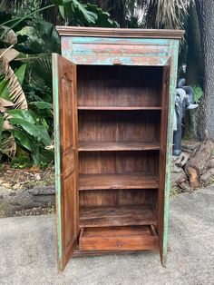 an old wooden bookcase sitting on the sidewalk