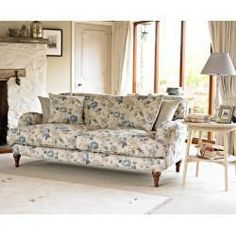 a living room filled with furniture next to a fire place in a fireplace mantel