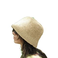 This hat is handmade and crafted from raffia yarn. Raffia yarn is a natural and durable material, ensuring the hat's longevity. The beige color and simple design make it an ideal accessory for both everyday use and outdoor activities like the beach. The wide-brim bucket shape provides sun protection and offers a stylish look. Its comfortable and lightweight structure ensures easy and prolonged wear. Raffia. You can store this hat, knitted from raffia rope, in a breathable cloth bag, protect it from fire and heat, and wipe the stains with a clean damp cloth. Yarn Sun Hat With Curved Brim, Natural Crochet Hat For Spring, Natural Crochet Hat With Curved Brim, Natural Curved Brim Crochet Hat, Natural Woven Wide Brim Bucket Hat, Wide Brim Natural Woven Bucket Hat, Wide Brim Woven Bucket Hat In Natural, Brimmed Woven Toquilla Straw Bucket Hat, Natural Wide Brim Toquilla Straw Bucket Hat