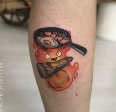 a person with a tattoo on their leg holding a frying pan and an egg