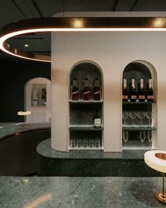 an elegant bar with wine bottles on the shelves