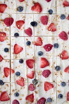 the dessert is topped with strawberries, blueberries and raspberries on it