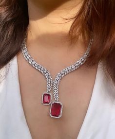 Gorgeous fine quality lab diamonds studded necklace with Ruby red stones in white gold rhodium plating and matching Earrings Item contains: Necklace and earrings  AAA quality cubic zirconia used. Highest quality and craftsmanship Necklace length- 18 inches( adjustable length) Necklace weight-35 gms Earrings length-2 inches  Each earring weighs-7 gms  Closure-Pushback In case of any queries, please feel free to reach out to us. Happy shopping! Formal Jewelry Sets With Cubic Zirconia Jewels, Diamond Necklace With Jewels, Diamond Jewel Necklaces For Anniversary, Diamond Jeweled Necklaces For Anniversary, Diamond Jeweled Necklace For Anniversary, Dazzling Round Diamond Necklace With Jewels, Diamond Necklaces With Jewels For Anniversary, Dazzling Round Diamond Necklace, Formal Jewelry With Jewels And Cubic Zirconia