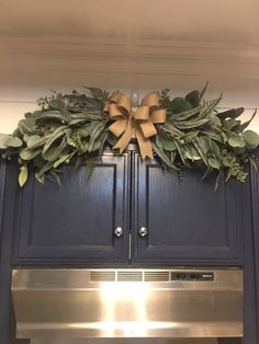 a wreath on top of an oven in a kitchen