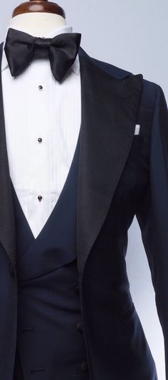 The classic navy tuxedo is a staple of any man's wardrobe. This elegant single-breasted Evening Wear tuxedo is tailored slim from soft, mid-weight, true blue mohair, and features our signature one-button placement, double vents, jetted pockets, natural shoulder, and wide peak lapels in grosgrain. The accompanying slim trousers are flat front with a wide waistband and feature our versatile side adjusters and classic tuxedo stripe. Bruce Buffer, Navy Blue Tuxedo, Blue Tuxedo Jacket, Red Overcoat, Brown Chukka Boots, Mens Wedding Suits, Navy Tuxedos, Blue Tuxedo, Grey Overcoat