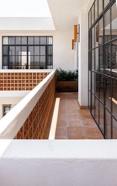 a balcony with glass doors and brick walls