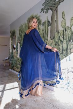 This kimono features an elegant longline design and sophisticated pattern with eye-catching tassels along the border. The fabric is lightweight and breezy, so you can flow with the wind as everyone admires your chic look. Plus, it's perfect for any summer or vacation outfit! Make sure to snap up your own Longline Tassel Border Kimono before they're all gone! #lovemyleto 100% Polyester Imported Long Kimono Outfit Dressy, Long Kimono Outfit, Sorority Rush Dresses, Kimono Outfit, Blue Kimono, Bachelorette Dress, Boho Layering, Casual Bodysuit, Rush Dresses