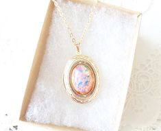 "A gorgeous gold plated photo locket adorned with a lovely pink fire opal dangles so pretty from a 16k gold plated link chain with lobster clasp. Total length of chain measures 18\" Locket measures 23x30mm Fire Opal measures 18x13mm Locket is high quality and nickel free Please note that this is not a real opal, but a faux opal glass cabochon with incredible fire and flecks of blue, yellow, green and pink Opal being the birthstone for October makes this a perfect birthday gift Your purchase will Pink Fire, Gold Locket Necklace, October Birthday, Gold Locket, Photo Locket, Pretty Cards, Pink Opal, Locket Necklace, Perfect Birthday