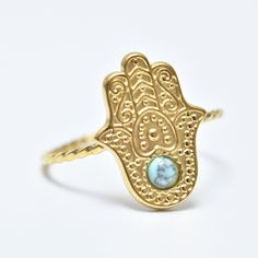 "Hamsa Ring, Blue Stone Hamsa Ring, Hamsa Ring, 18K Gold Ring, Adjustable Ring, Evil Eye Ring, Gold Filled, Stackable Ring, Gift for Her, Gift for Wife. Free international shipping Hamsa ring inlaid with  blue stone in 18K gold plating, the ring is designed in the shape of  classic hamsa. The pendant in the shape of hamsa eye is studded with special stone. Hamsa ring is  symbol of protection against the evil eye. She is  symbol of protection, good luck and spirituality. This ring is  perfect gift for anyone you want to protect. The stone embedded in the ring is  symbol of light and resurrection. It is considered  symbol of hope, happiness and protection. Add these simple yet stylish rings to your collections, bold and confident. They really go with everything!! ∙ Metal type: 18K gold plati Adjustable Gold Turquoise Ring In Spiritual Style, Adjustable Gold Spiritual Turquoise Ring, Gold Adjustable Turquoise Ring, Adjustable Gold Turquoise Ring, Adjustable Gold Turquoise Gemstone Ring, Gold Turquoise Open Ring As A Gift, Adjustable Symbolic Gemstone Rings, Gold Turquoise Ring Gift, Adjustable Gold Turquoise Ring For Wedding