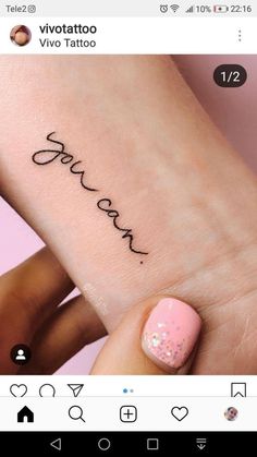 someone has written their name on the wrist and it is in cursive writing