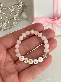 "This dainty Pink Matte Rose Quartz Gemstone Bracelet set With an 18K Gold plated Zirconia Rhinestone Cross is the cutest accessory ever! It is the best way to show off the ❤️. l Love between you and your little girl! ❣️Be sure to favorite/heart this shop, as new pieces are added frequently! ❣️ Customizable worded bracelet stacks. Perfect for birthdays, gender reveals, Communion, Baptism, baby announcements, mamas and their babes, Valentine Gift, Best Friends... The 18K plated Gold Cross bead an Personalized Jewelry For Baptism And Mother's Day, Personalized Pink Beaded Bracelets For Wedding, Pink Name Bracelet, Personalized Dainty Jewelry For First Communion, Dainty Personalized Jewelry For First Communion, Pink Dainty Jewelry For Personalized Gifts, Dainty Pink Jewelry For Personalized Gift, Personalized Pink Bracelets For Wedding, Customizable Pink Jewelry For Wedding