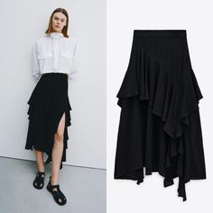 High-Waisted Midi Skirt. Tonal Matching Ruffles. Asymmetric Hem. Back Hidden In-Seam Zip Closure. Black Asymmetrical Hem Draped Skirt For Work, Black Draped Skirt With Asymmetrical Hem For Work, Chic Black Draped Skirt With Asymmetrical Hem, Chic Black Asymmetrical Draped Skirt, Chic Black Draped Skirt For Workwear, Black Asymmetrical Hem Skirt For Work, Spring Asymmetrical Hem Maxi Skirt With Ruffles, Chic Ruffled Skirt Bottoms For Fall, Summer Workwear Draped Skirt Lined