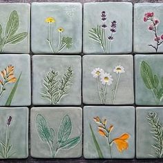 nine square tiles with flowers painted on them