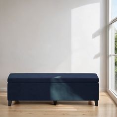 a blue bench sitting in front of a window on top of a hard wood floor