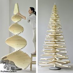 a woman standing next to a wooden christmas tree made out of strips of plywood