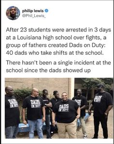 some people are standing together in front of a building and one is wearing black t - shirts