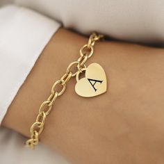 Introducing our 18k Disc Gold Plated Initial Bracelet--a perfect blend of elegance and personal flair. This stunning bracelet features a delicate heart pendant, measuring 20mm x 20mm, crafted from 18k gold-plated stainless steel. Whether you're treating yourself or finding a special gift, this piece combines timeless charm with modern durability. This bracelet is not only a stylish accessory but also practical. It's waterproof and hypoallergenic, making it a great choice for everyday wear. The 1 Classic Heart Shaped Chain Bracelet As Gift, Classic Heart-shaped Chain Bracelet As Gift, Classic Heart-shaped Chain Bracelet Gift, Classic Heart Pendant Bracelet As Gift, Classic Gold Plated Charm Bracelet Gift, Yellow Gold Charm Bracelet For Valentine's Day Gift, Heart-shaped Stainless Steel Bracelets For Weddings, Yellow Gold Charm Bracelet Gift For Valentine's Day, Elegant Stainless Steel Heart Bracelet For Anniversary