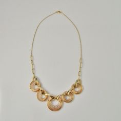 A fine hand made 1940s high art deco necklace in rose and yellow gold. This divine necklace features a central hand made focus that is hand crafted in rose and yellow gold. The design is exceptionally streamlined. The necklace measures 17" long and is 13/16" wide (432mm x 20mm). Made from fine 14K rose and yellow gold it weighs a total of 23.19 grams. It is in excellent condition.This is a one of a kind original art deco necklace not a reproduction item in the deco style. An appraisal shall acco Vintage 14k Gold Necklace With Adjustable Chain, Rose Gold Round Necklace With Gold Chain, Rose Gold Necklace With Round Gold Chain, Rose Gold Necklace With Gold Chain, Vintage Gold-plated Jewelry With Delicate Chain, Brass Rose Gold Necklace For Jewelry Making, Rose Gold Heirloom Necklace For Formal Occasions, Heirloom Rose Gold 14k Gold Necklace, Heirloom 14k Rose Gold Necklace