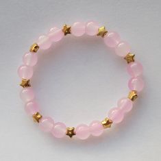 beaded string bracelet with pink glass beads and small golden star beads features: - this product is handmade :) - currently only available in pink - length of bracelet is 6.5 inches but it is made with stretchy bracelet cord so it can stretch up to 8 inches note: - product color may look different under various lighting conditions Starry Sunset, Sunset Bracelet, Bracelet Cord, Star Beads, Golden Star, String Bracelet, Stretchy Bracelets, Bead Stringing, Resin Beads