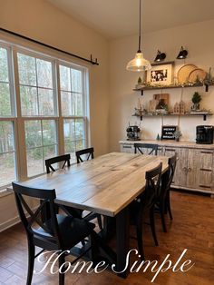 a dining room table and chairs in front of a window with the words home simple on it