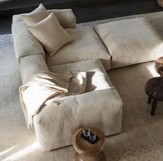 a living room filled with lots of furniture on top of a white carpeted floor