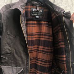 Breathable, Collared, Lightweight, Limited Edition, Pockets, Water Resistant, Waxed, Windproof, Zipped Pockets. Mid-Length, Perfect For Outdoor Activities In The Fall/Spring. Filson Jacket, Field Jacket, In The Fall, The Fall, Brown Color, Mid Length, Outdoor Activities, Zip Pockets, Mens Jackets