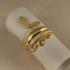 Snake ring made of 18 carat solid yellow gold Snake was the symbol of health in ancient Greece It's made with detailed handmade workmanship Made in Greece in our workshop in Athens A beautiful piece of jewelry that can be an unique gift for any special occasion For more information don't hesitate to contact us SHIPPING INFORMATION FREE SHIPPING VIA DHL EXPRESS Please fill in an active phone number It's required by the courier company DELIVERY TIME INFORMATION 1 - 3 Days EUROPE 3 - 5 Days to U.S. Ancient Greek Coin, Lion Ring, Clip On Charms, Greek Coins, Head Ring, Coin Ring, Snake Ring, Gold Snake, Ancient Greece