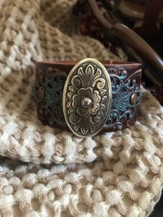 "🔸🔸orders are delayed by a few days this week. Thank you for your patience Country leather bracelet cuff, western jewelry Embossed distressed genuine brown leather 1 1/2\" strap has been adorned with an oval southwestern silver concho which sets on a detailed antiqued copper filigree which has been given a rich patina. It is attached to the leather with two antiqued copper rivets. One antiqued copper snap has been placed to fit up to a 7 1/4\" wrist. I can add another snap if you would like a Cowgirl Bracelets, Chunky Bracelet, Santa Clarita, Chunky Bracelets, Bracelet Leather, Bracelet Cuff, Leather Cuffs Bracelet, Western Jewelry, Dark Brown Leather