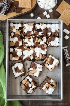 s'mores brownies on a baking sheet with marshmallows and chocolate