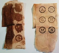 two pieces of cloth with letters and numbers on them, one has been cut out