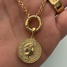 Fine casting made Queen Elizabeth inspired coin pendant in 18k gold filled. A great addition for those looking to have many pendants in a necklace or even bracelet. You may create your own collection, exploring the possibilities of jewelry making or diy (do it yourself) jewelry. Size with bail: 1" length Coin diameter: 0.75 inches Hypoallergenic jewelry Guarantee against tarnish Water resistant Rigorously manufactured under CA Prop 65 and EU standards Made in Brazil Have available the best jewel The Queen Of England, Outer Core, Creative Department, Queen Of England, Jewelry Metal, Bracelet Chain, Hypoallergenic Jewelry, Exclusive Jewelry, Solid Gold Jewelry