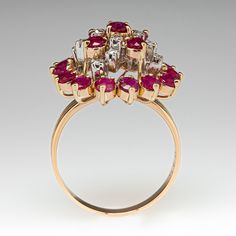 This beautiful cluster cocktail ring is three-prong set with nineteen (19) round mixed cut rubies. The top of the ring is accented with twelve (12) round single cut diamonds, in four-prong settings. The ring measures 19.8mm at the top, rises 11.5mm above the finger, tapering to 2.2mm wide and 0.7mm thick at the base of the shank. This ring is currently a size 8.25. Classic Ruby Ring With Rose Cut Diamond Cluster, Formal Ruby Ring With Diamond Accents In Cluster Shape, Formal Cluster Ruby Ring With Diamond Accents, Ruby Ring With Diamond Cluster And Brilliant Cut, Red Diamond Cluster Ring With Halo Setting, Classic Red Cluster Diamond Ring, Red Cluster Diamond Ring With Brilliant Cut, Cluster Ruby Ring With Brilliant Cut Diamonds, Cluster Ruby Ring With Rose Cut Diamonds