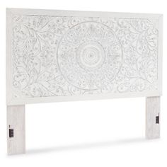 a white headboard with an intricate design on the top and bottom panel, made out of wood