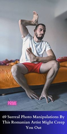 a man sitting on top of a bed with his hands up in the air while wearing red trunks