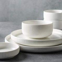 white dinnerware set on grey surface with plates