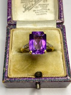 An incredible antique art deco 18 karat gold ring. Featuring a beautiful emerald cut rectangular purple amethyst set on a high setting with two small natural diamonds to the left and right set in platinum. A real cocktail ring! Hallmarked 18ct inside the band. Very eyecatching and full of sophistication! Circa 1920's. Amethyst is the birthstone of February and is associated with peace, cleansing and calming energy. Size UK/AUS P Size US 7.5 The face of the amethyst measures: The length is 11mm and the width is 9mm. Condition: In really good antique condition. Minimal scratches to the amethyst due to age. Please look at the photos as they are truly representative of the condition of this amazing ring! Use the code MAGICJEWELS20 for €20 off when TWO ITEMS are bought in one purchase All items Luxury Heirloom Amethyst Ring For Formal Occasions, Elegant Rectangular Amethyst Ring For Formal Occasions, Art Deco Rings With Rectangular Stone For Formal Occasions, Classic Amethyst Ring With Rectangular Stone For Formal Occasions, Vintage Rectangular Gemstone Rings, Elegant Amethyst Ring With Rectangular Stone For Formal Occasion, Elegant Formal Amethyst Ring With Rectangular Stone, Formal Rectangular Fine Jewelry Gemstones, Elegant Rectangular Gemstones For Formal Events