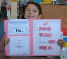 a child holding up a pink and white sign with words on it that say the i can't spell