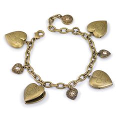 "This charming little bracelet features four functional heart locket charms and heart charms inset with crystal. Lockets are delicately engraved with heart motifs. Each locket holds two photos, allowing you to carry eight cherished photos of loved ones everywhere you go! Your children or grandchildren, perhaps? Or maybe a locket dedicated to each of your best friends! Choice of silver metal or burnished bronze finish. Comes in a black suede pouch for gifting. Made in our Los Angeles, CA studio. Heart Locket Bracelet, Valentines Bracelets, Locket Bracelet, Jewelry Lockets, Vintage Lockets, Coin Earrings, Locket Charms, Bridal Bracelet, Charm Bangle