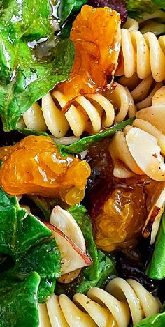 pasta salad with spinach and dried fruit in it, closeup view from above