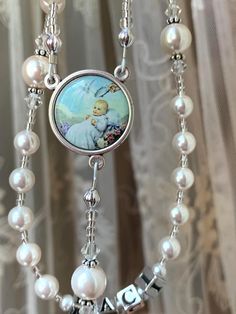 Beautiful white pearl rosary. You can choose your medals and it can be personalized with a name or initials! Can be for any Catholic sacrament - baptism, first holy communion, confirmation, or wedding. Handmade Silver Rosary Bracelet For First Communion, Handmade Silver Rosary For Baptism, White Necklace With Miraculous Medal And Round Beads, Handmade Silver Rosary Bracelet For Baptism, Handmade White Rosary Bracelet For Baptism, Personalized Rosary For First Communion, Handmade Rosary Bracelet With Round Beads For Baptism, Handmade Adjustable Rosary For First Communion, Beaded Rosary For Baptism