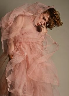 a woman in a pink dress posing for the camera