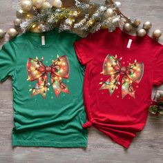 Christmas Bow T-shirt, Christmas Light Coquette Bow shirt, Couples Tee for Christmas Eve Party T-shirt, Xmas Holiday Themed Tee Check it out our other Most Likely To Shirts and Sweatshirts; https://www.etsy.com/shop/MyNewCustomTshirt?section_id=45667553 Our personalized t-shirts are made from high-quality materials that feels great against your skin. With a range of colors and designs to choose from, you're sure to find a shirt that matches your personality and style. Whether you're looking for a funny graphic tee, a statement piece with bold, eye-catching artwork, or a classic design with a twist, we have something for everyone. Perfect for casual outings, concerts, or even just lounging around the house, our t-shirts are comfortable, stylish, and versatile. Plus, they make great gifts fo Christmas Festive Shirt With Graphic Print, Festive Christmas Graphic Print Shirt, Green Christmas T-shirt For Holiday, Red Holiday Shirt For Gift, Holiday Red Shirt As Gift, Red Holiday Shirt Gift, Pre-shrunk Short Sleeve Christmas Tops, Graphic Print Top As Christmas Gift, Green T-shirt For Christmas Holiday