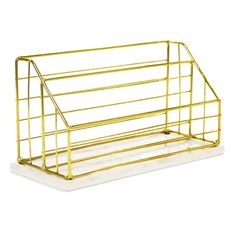 a gold metal magazine rack on a white background