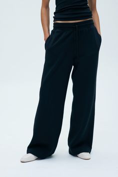 The epitome of casual elegance. With a relaxed A-line silhouette, these sweats are easily dressed up with an overshirt—perfect for comfort on the go. Mix and match with our sweat fleece tops to complete the tone-on-tone set. Women's Wide Leg Sweatpant Comfortable Black Wide Leg Sweatpants, Black Wide Leg Sweatpants With Pockets, Black Wide-leg Sweatpants, Black Non-stretch Wide Leg Sweatpants, Black Relaxed Fit Sweatpants With Double-needle Hem, Outdoor Aesthetic, Casual Elegance, Mix N Match, Dressed Down