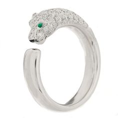 This is an authentic CARTIER 18K White Gold Diamond Black Onyx Emerald Panthere De Cartier Ring 55 7.25. The ring is crafted of 18-karat white gold and features a panther shape encrusted with diamonds weighing approximately .68 total carat weight with a black onyx nose and two emerald eyes. Luxury Cartier White Gold Diamond Ring, Cartier Luxury White Gold Diamond Ring, Cartier White Gold Diamond Ring Vs Clarity, Cartier Silver Rings With Diamond Accents, Cartier White Gold Rings With Diamond Accents, Luxury Cartier Rings With Round Cut, Luxury Cartier Rings In Diamond White, Luxury Diamond White Ring With Polished Finish, Luxury Diamond White Rings With Polished Finish