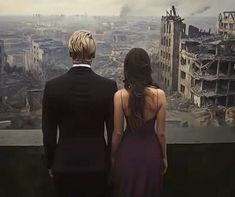 two people standing in front of a cityscape looking out at the destroyed buildings