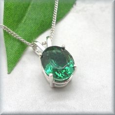 A vivid oval simulated emerald rests in a sterling silver basket setting. The simplicity of the pendant showcases the beauty of the emerald stone. Emeralds are the May birthstone. The oval simulated emerald measures 10x8mm. The setting and curb chain are both 925 sterling silver. Simulated emeralds are lovely and this is an affordable way to have one of your own. Items are shown larger in pictures to show detail - please note the dimensions. Jewelry is packaged in a cotton lined box for gift-giv Silver Basket, Emerald Style, May Birthday, Basket Setting, May Birthstone, Elegant Pendant, Emerald Necklace, Jewelry Birthday, Emerald Stone